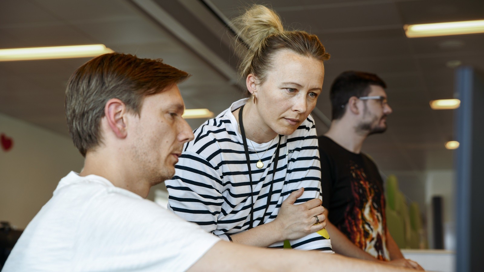 KMD Poland employees looking at a screen together at a desk